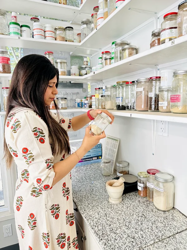 Preeti Gupta with herbs and oils at the Minute Wonder Ayurveda clinic in San Ramon